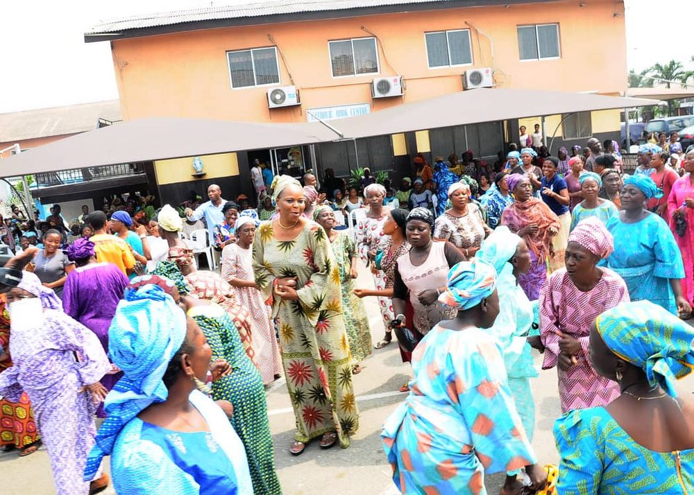Elderly women and volunteers dancing together at a Mothers Forever Foundation gathering