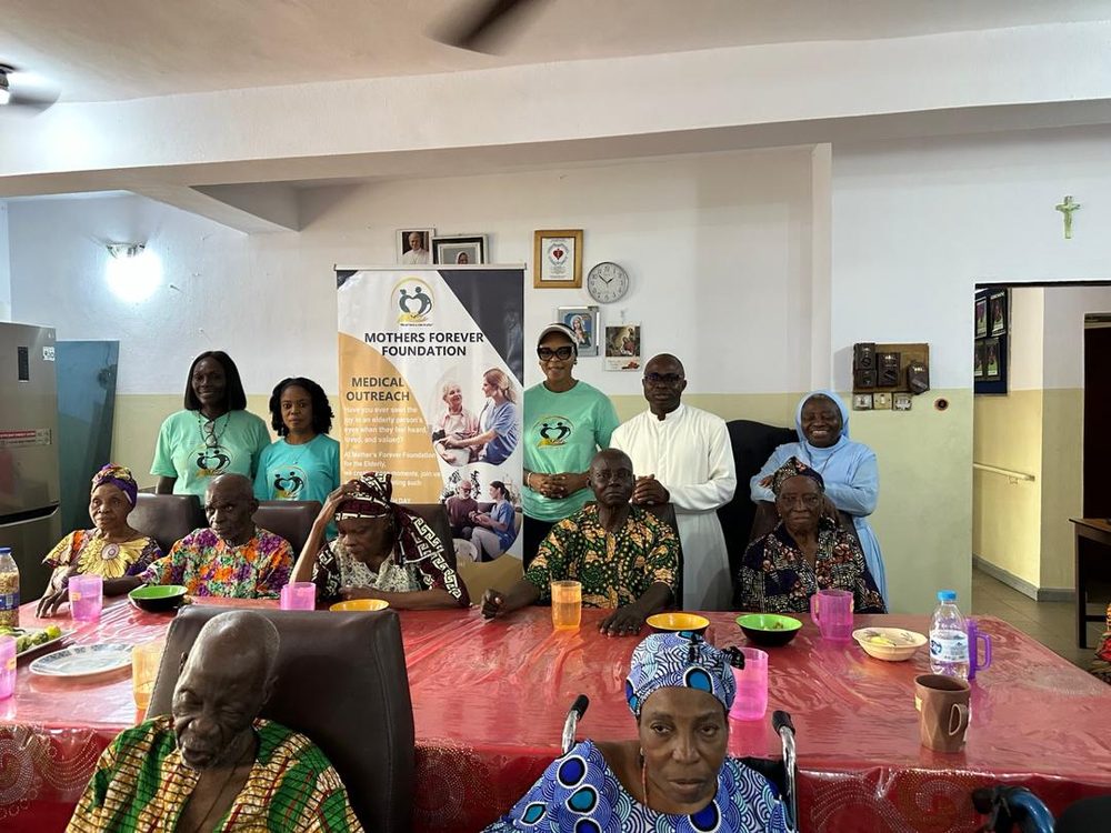 Elderly residents seated at a table during a Mothers Forever Foundation medical outreach