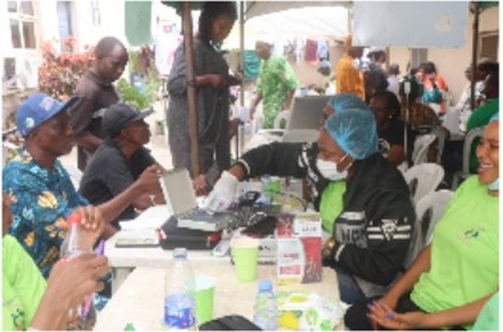 Volunteers registering elderly attendees at a medical outreach