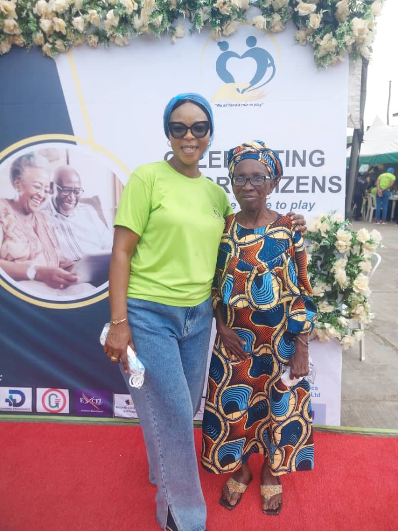 A volunteer with an elderly woman at a Celebrating Senior Citizens event